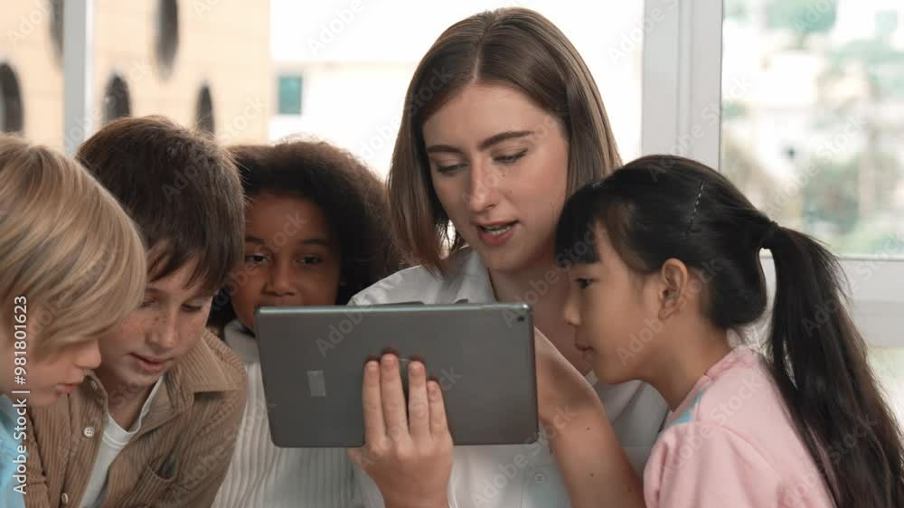 Smart teacher holding tablet while open online lesson to group of students. Skilled instructor explained engineering code lesson while young learner sitting and listening presentation. Erudition. Smart teacher holding tablet while open online lesson to group of students. Skilled instructor explained engineering code lesson while young learner sitting and listening presentation. Erudition.