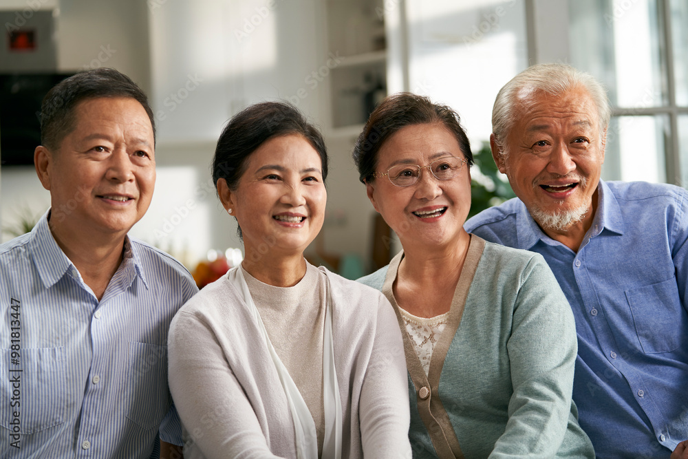 group of happy senior asian people watching tv at home group of happy senior asian people watching tv at home