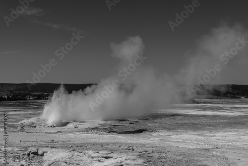 Blank and white photograph of fountain geyser erupting at the fountain paint pit trail in Yellowstone National Park, Wyoming.