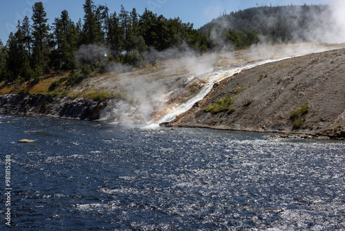 Excelsior geyser runoff hot steam rising from the water flow cascading falling into the firehouse river at Yellowstone national park in Wyoming photo