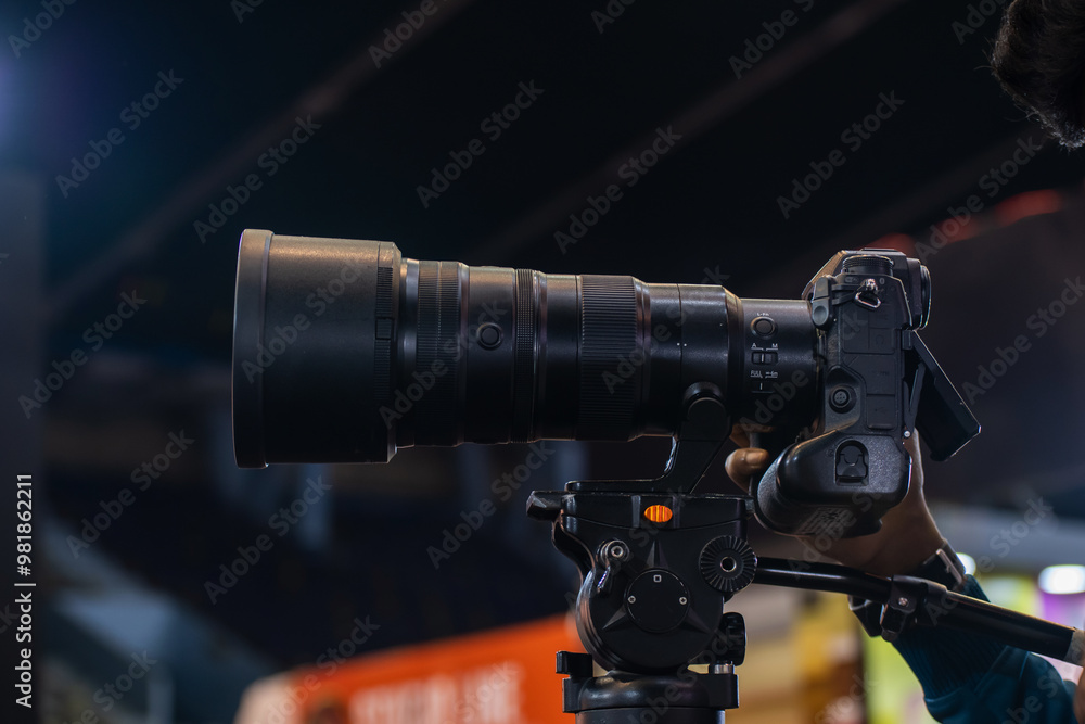 Close-up of a photographer using telephoto lens to captured a moment Close-up of a photographer using telephoto lens to captured a moment