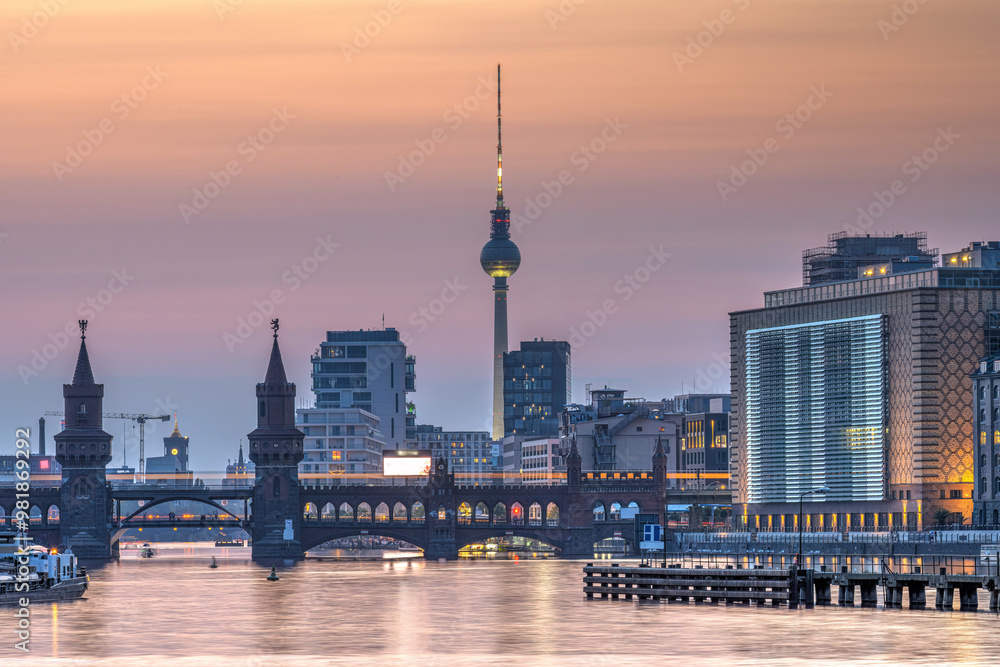 Fototapeta premium Berlin with the river Spree after sunset with the Oberbaum Bridge and the famous Television Tower