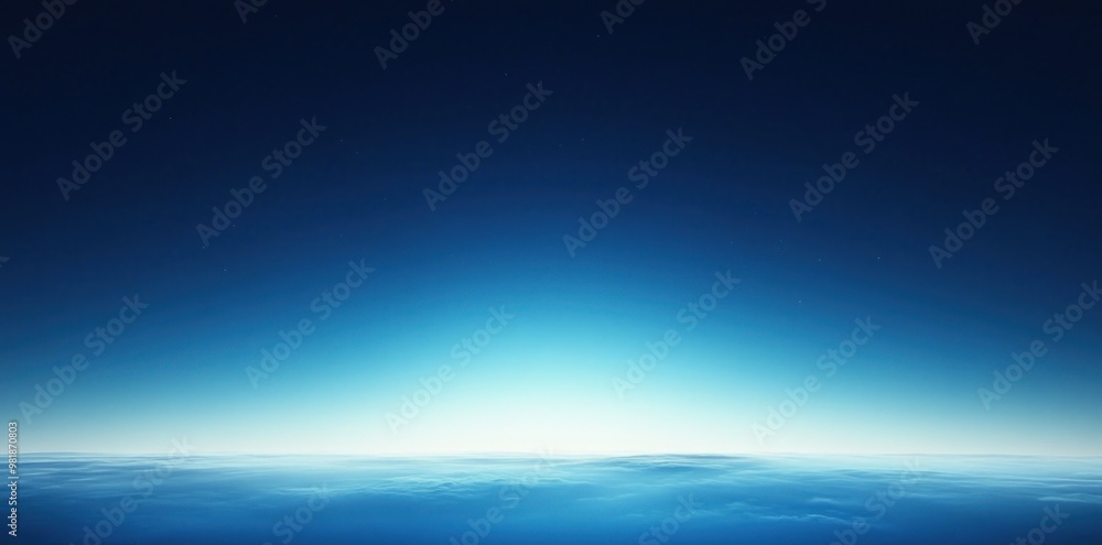 An aerial view of a vast expanse of clouds with a gradient blue sky above. An aerial view of a vast expanse of clouds with a gradient blue sky above.