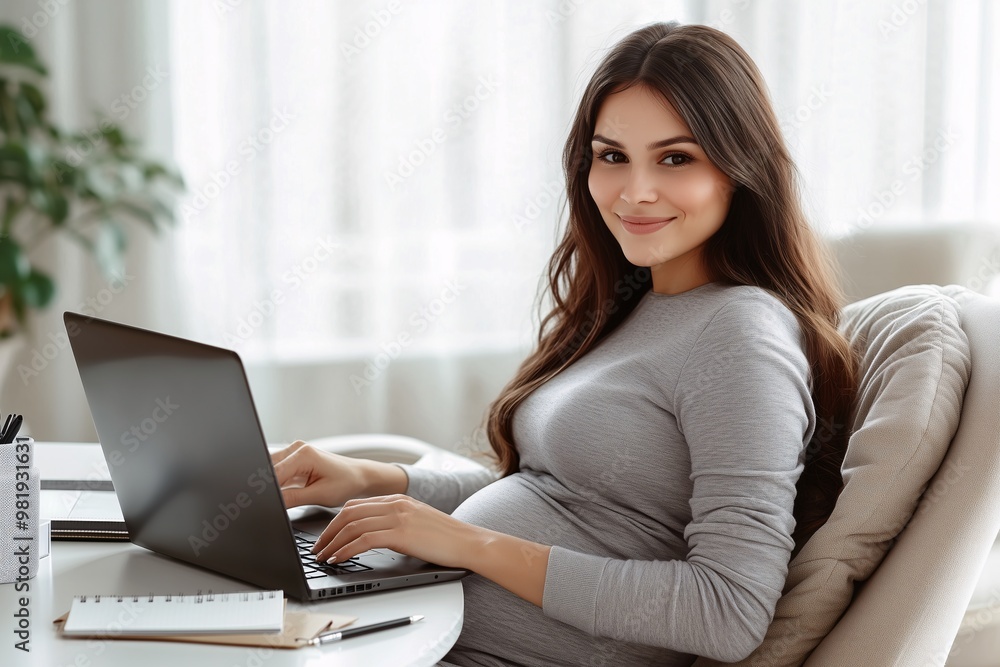 Fototapeta premium pregnant woman in casual clothes sits at a desk, on the desk there is a laptop, concept of women's health, pregnancy planning, happiness of motherhood, affordable work, poster for social projects