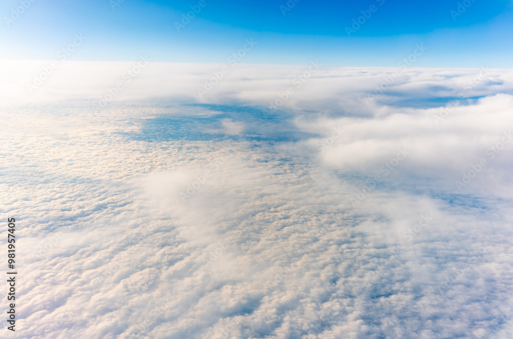 View from the airplane window at a beautiful cloudy sky and the airplane wing View from the airplane window at a beautiful cloudy sky and the airplane wing