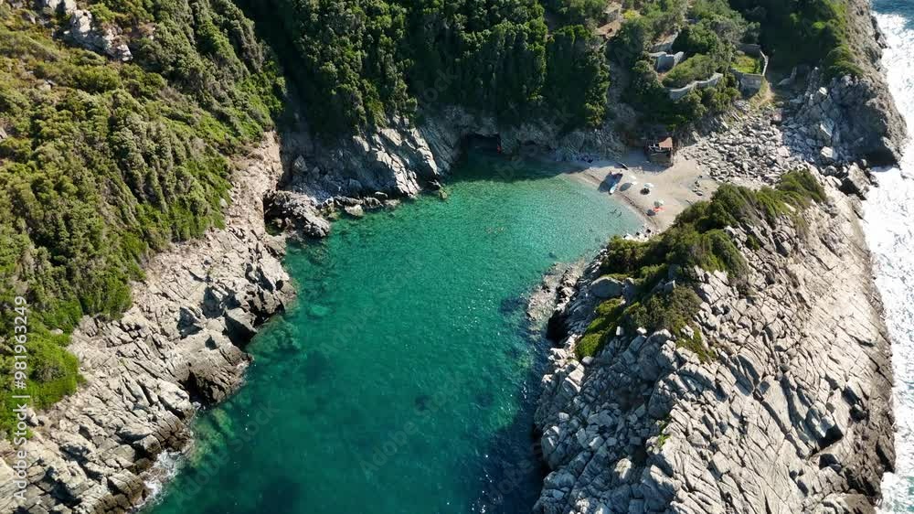 A secluded beach surrounded by cliffs and turquoise water, aerial view A secluded beach surrounded by cliffs and turquoise water, aerial view