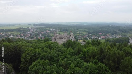 Flying from the forest over the ruins of medieval castle in Ogrodzieniec Poland (the one from Witcher movie)