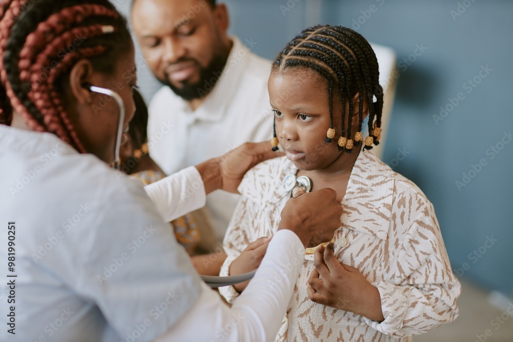 © AnnaStills - Child receiving medical examination with stethoscope by professional medical practitioner with other adults in background looking with concern © AnnaStills - Child receiving medical examination with stethoscope by professional medical practitioner with other adults in background looking with concern