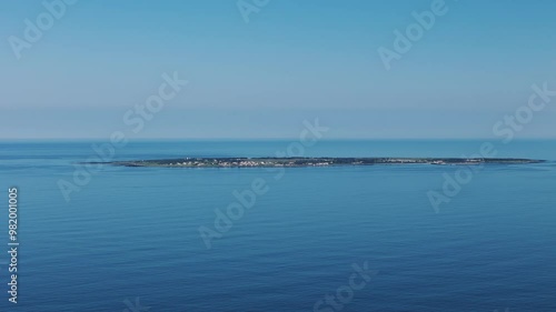 Drone clip of Robben Island in Cape Town where Nelson Mandela was imprisoned surrounded by beautiful blue calm ocean waters