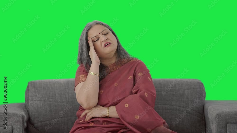 Sick Indian old woman suffering from headache Green screen Sick Indian old woman suffering from headache Green screen