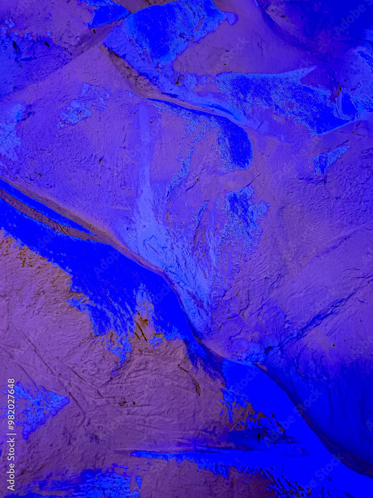 Naklejka premium Textured blue landscape patterns. Textured surface illuminated in vibrant blue, showcasing intricate patterns akin to abstract topography or natural formations.