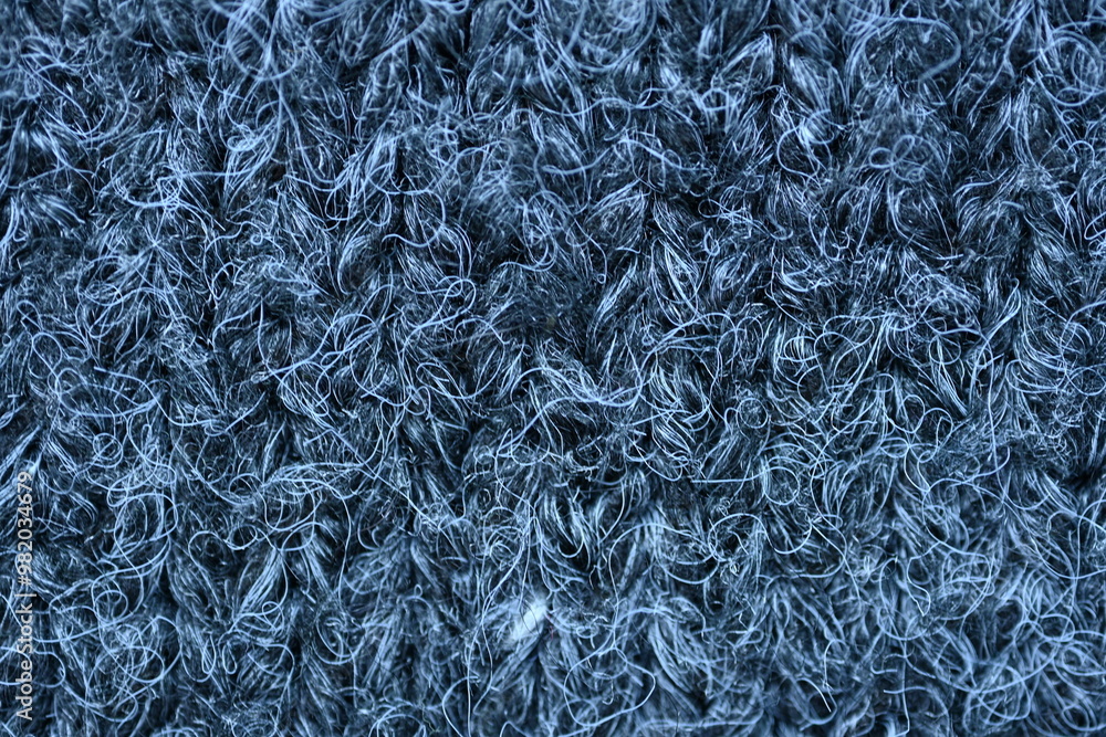 close-up of gray crocheted front surface, woolen texture of woolen wool, knitted front surface, macro texture of woolen dark gray crocheted sweater as background close-up of gray crocheted front surface, woolen texture of woolen wool, knitted front surface, macro texture of woolen dark gray crocheted sweater as background