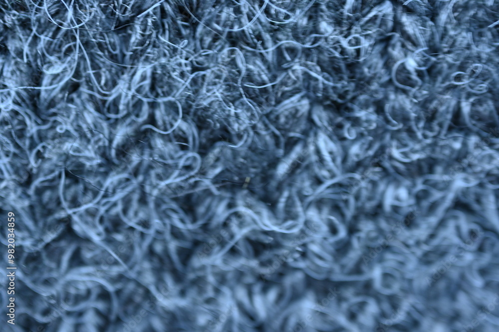 close-up of gray crocheted front surface, woolen texture of woolen wool, knitted front surface, macro texture of woolen dark gray crocheted sweater as background close-up of gray crocheted front surface, woolen texture of woolen wool, knitted front surface, macro texture of woolen dark gray crocheted sweater as background