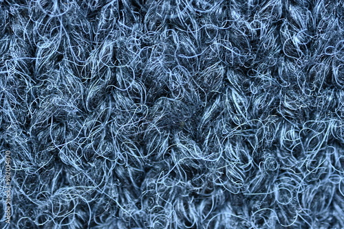  close-up of gray crocheted front surface, woolen texture of woolen wool, knitted front surface, macro texture of woolen dark gray crocheted sweater as background photo