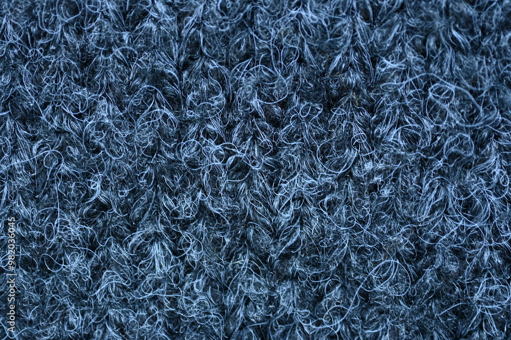 close-up of gray crocheted front surface, woolen texture of woolen wool, knitted front surface, macro texture of woolen dark gray crocheted sweater as background close-up of gray crocheted front surface, woolen texture of woolen wool, knitted front surface, macro texture of woolen dark gray crocheted sweater as background