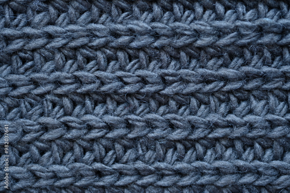 macro texture of woolen dark gray crocheted sweater as background, close-up of gray crocheted front surface, woolen texture of woolen wool, knitted front surface macro texture of woolen dark gray crocheted sweater as background, close-up of gray crocheted front surface, woolen texture of woolen wool, knitted front surface