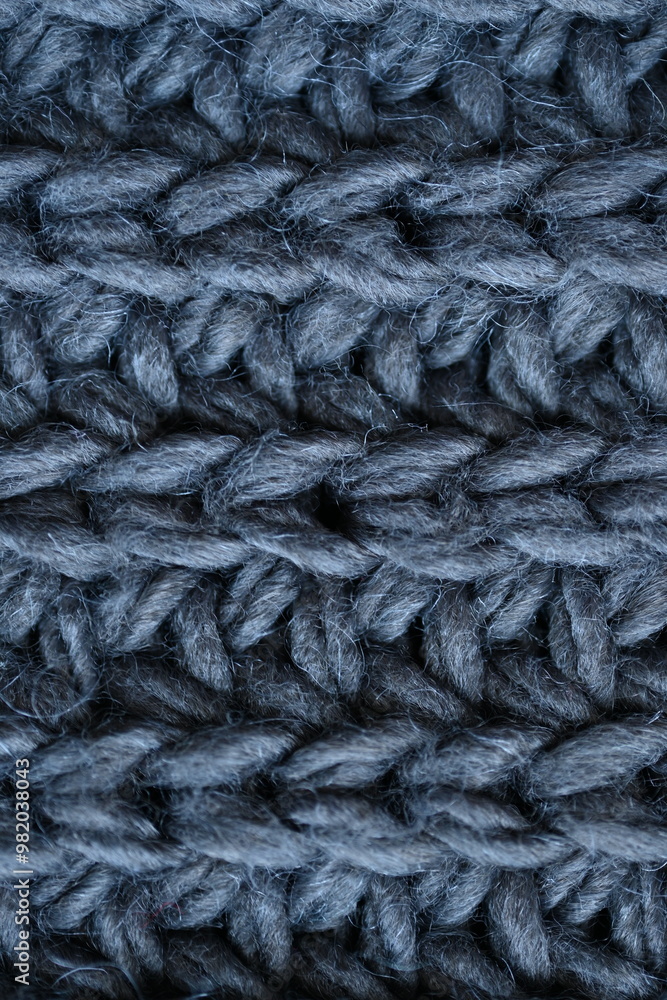 macro texture of woolen dark gray crocheted sweater as background, close-up of gray crocheted front surface, woolen texture of woolen wool, knitted front surface macro texture of woolen dark gray crocheted sweater as background, close-up of gray crocheted front surface, woolen texture of woolen wool, knitted front surface