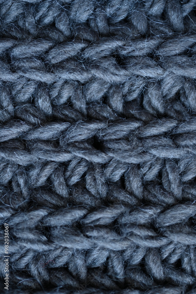 macro texture of woolen dark gray crocheted sweater as background, close-up of gray crocheted front surface, woolen texture of woolen wool, knitted front surface macro texture of woolen dark gray crocheted sweater as background, close-up of gray crocheted front surface, woolen texture of woolen wool, knitted front surface