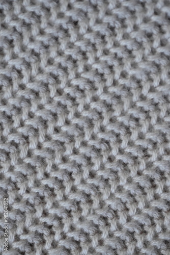 macro texture of woolen pastel crocheted sweater as background, close-up of brown crocheted front surface, woolen texture of woolen wool, trend pastel crocheted front surface photo