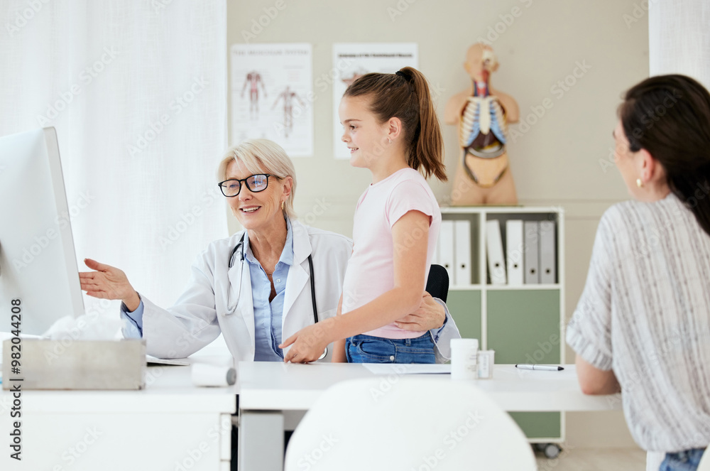 Obraz premium Pediatrician, mom and child with computer for results, medical diagnosis or good news. Happy kid, parent and girl patient in clinic consultation with mature healthcare doctor and family in hospital