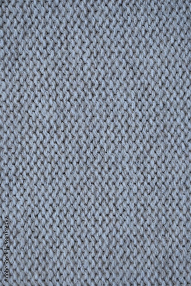 Macro texture of woolen brown crocheted sweater as background, close-up of beige crocheted front surface, woolen texture of woolen wool, crocheted front surface Macro texture of woolen brown crocheted sweater as background, close-up of beige crocheted front surface, woolen texture of woolen wool, crocheted front surface