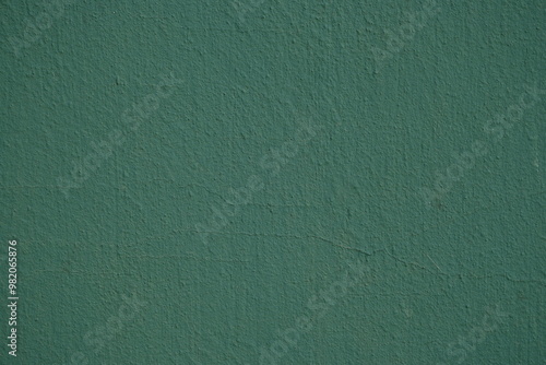 Фотография texture of putty painted gree gently orange painted wall green plaster backgroun
