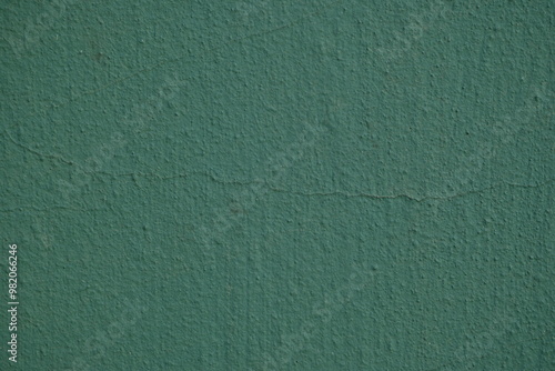 Фотография texture of putty painted gree gently orange painted wall green plaster backgroun