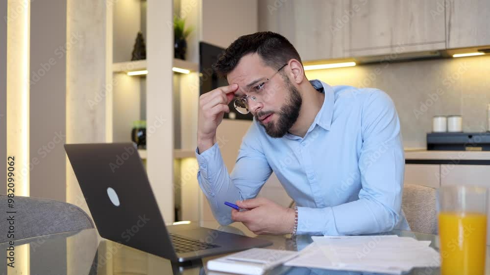 Man managing his monthly finances at home Man managing his monthly finances at home