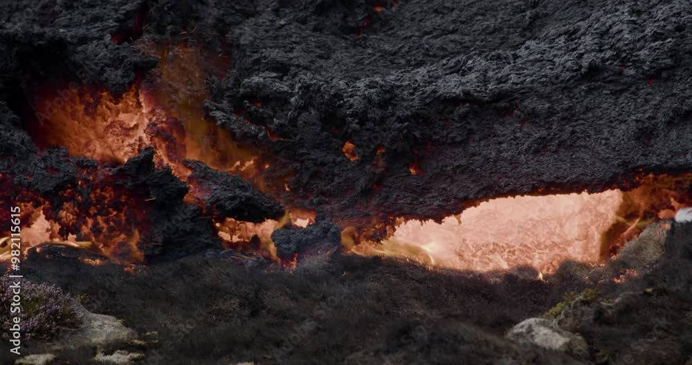 Close-up of molten lava slowly flowing from Grindavik volcano in Sundhnúkur crater, Iceland. Close-up of molten lava slowly flowing from Grindavik volcano in Sundhnúkur crater, Iceland.