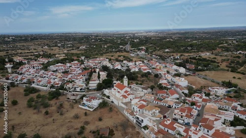 Wide drone shot way over beautiful Portugal Algarve Town of Porches drone flying forward photo