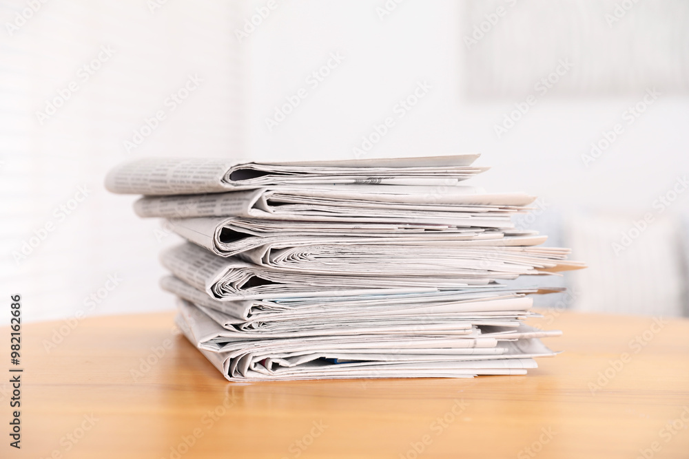 Stack of many newspapers on wooden table Stack of many newspapers on wooden table