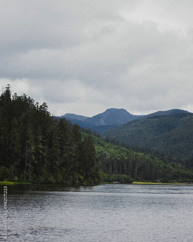 Tranquil lake surrounded by lush green mountains and forest. Tranquil lake surrounded by lush green mountains and forest.