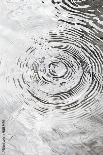 This captivating image showcases a mesmerizing abstract ripple effect. The intricate patterns create a sense of movement and depth against a clean white background, adding a modern touch.