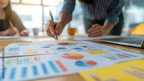 A close-up of a nonprofit leader presenting a fundraising strategy to their team, with visual aids and donor data photo