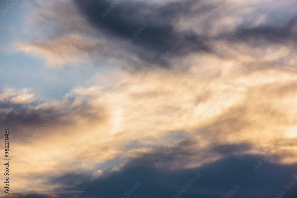 Magnificent sunset cloudy glowing sky of gold colors. Dramatic colorful nature background with dawn skies of sunrise vivid orange tones. Beautiful contrast texture of golden clouds in luminous sky. Magnificent sunset cloudy glowing sky of gold colors. Dramatic colorful nature background with dawn skies of sunrise vivid orange tones. Beautiful contrast texture of golden clouds in luminous sky.