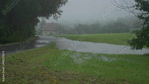 Wide static shot of flooded road and field photo