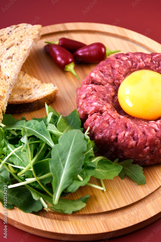 Tartar with egg and arugula. fresh ground meat with seasonings. fresh greens. Tartar with egg and arugula. fresh ground meat with seasonings. fresh greens.