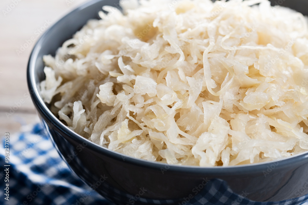 Sauerkraut in a bowl on wooden table. Traditional german food. Close up Sauerkraut in a bowl on wooden table. Traditional german food. Close up