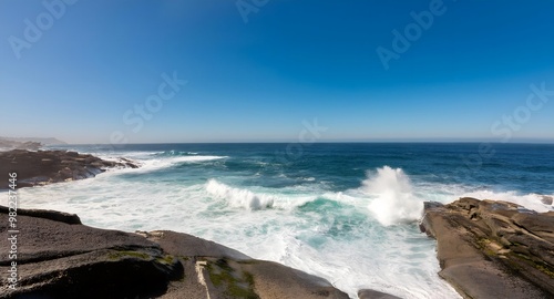 Waves crashing against a rocky coastline, with white foam wide angle