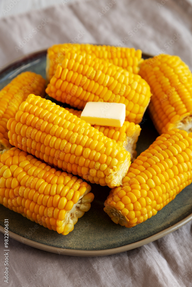 Homemade Organic Steamed Yellow Sweet Corn on the Cob with Butter, side view. Homemade Organic Steamed Yellow Sweet Corn on the Cob with Butter, side view.