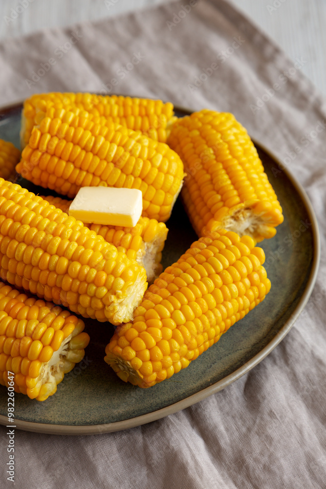 Homemade Organic Steamed Yellow Sweet Corn on the Cob with Butter, side view. Homemade Organic Steamed Yellow Sweet Corn on the Cob with Butter, side view.