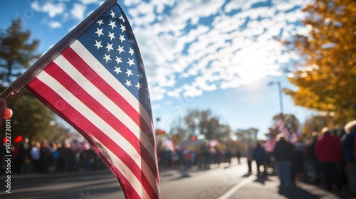 American flag held at patriotic event with people and blue sky photo