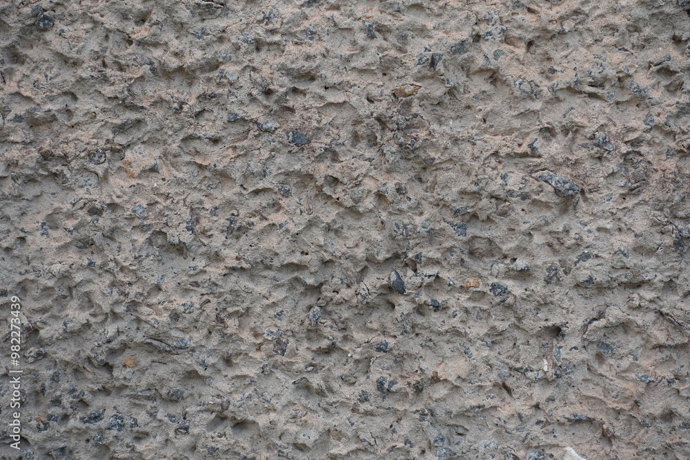 Closeup of gray wall with unpainted cement roughcast finish Closeup of gray wall with unpainted cement roughcast finish