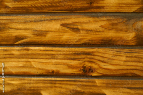 Closeup of wall with burnt and brushed split log siding photo