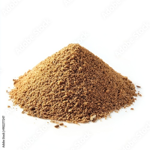 A small pile of ground cumin spice on a white surface.