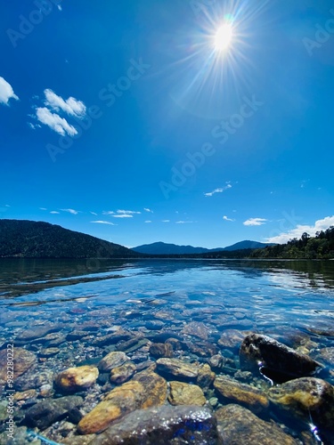 Beautiful Lake Paringa on the sunny day with clear blue sky, West coast, South Island, New Zealand. Landscape with lake and mountains photo