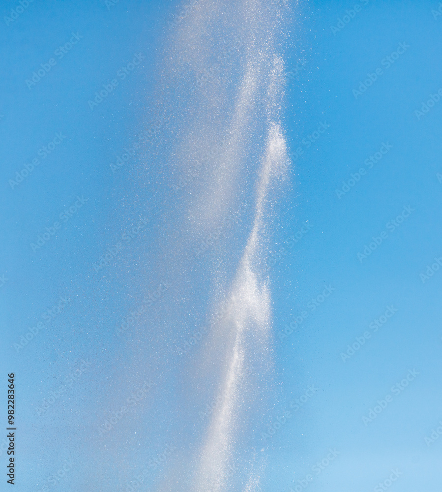 Water splashes from a fountain against a blue sky Water splashes from a fountain against a blue sky