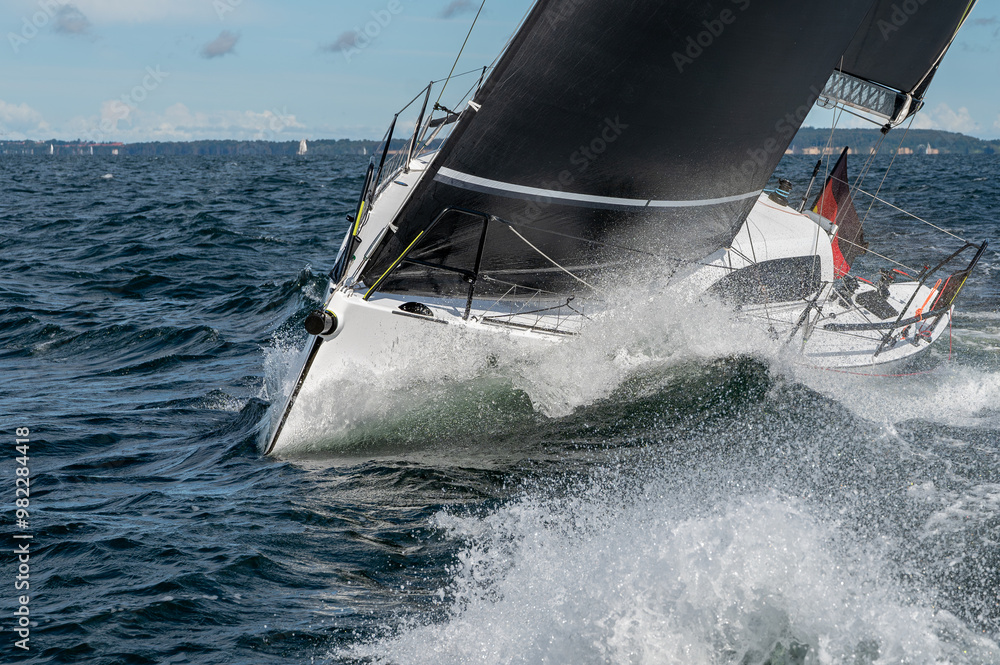 Naklejka premium Segelyacht an der Kreuz mit spritzenden Wellen