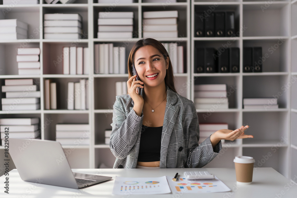 Businesswoman talking with colleague on smartphone to explaining data about new business project Businesswoman talking with colleague on smartphone to explaining data about new business project