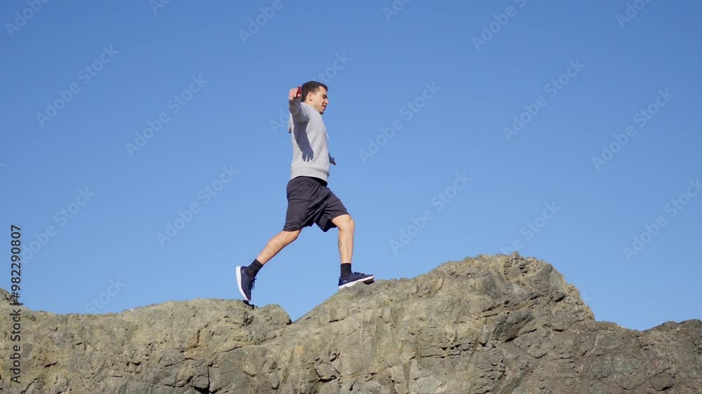 Young moroccan man walking on a cliff. Risk and comfort zone concept Young moroccan man walking on a cliff. Risk and comfort zone concept